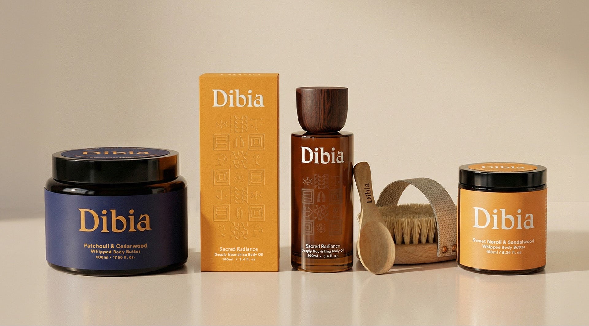 Dibia grooming products including a jar, box, bottle, and brush on a neutral background