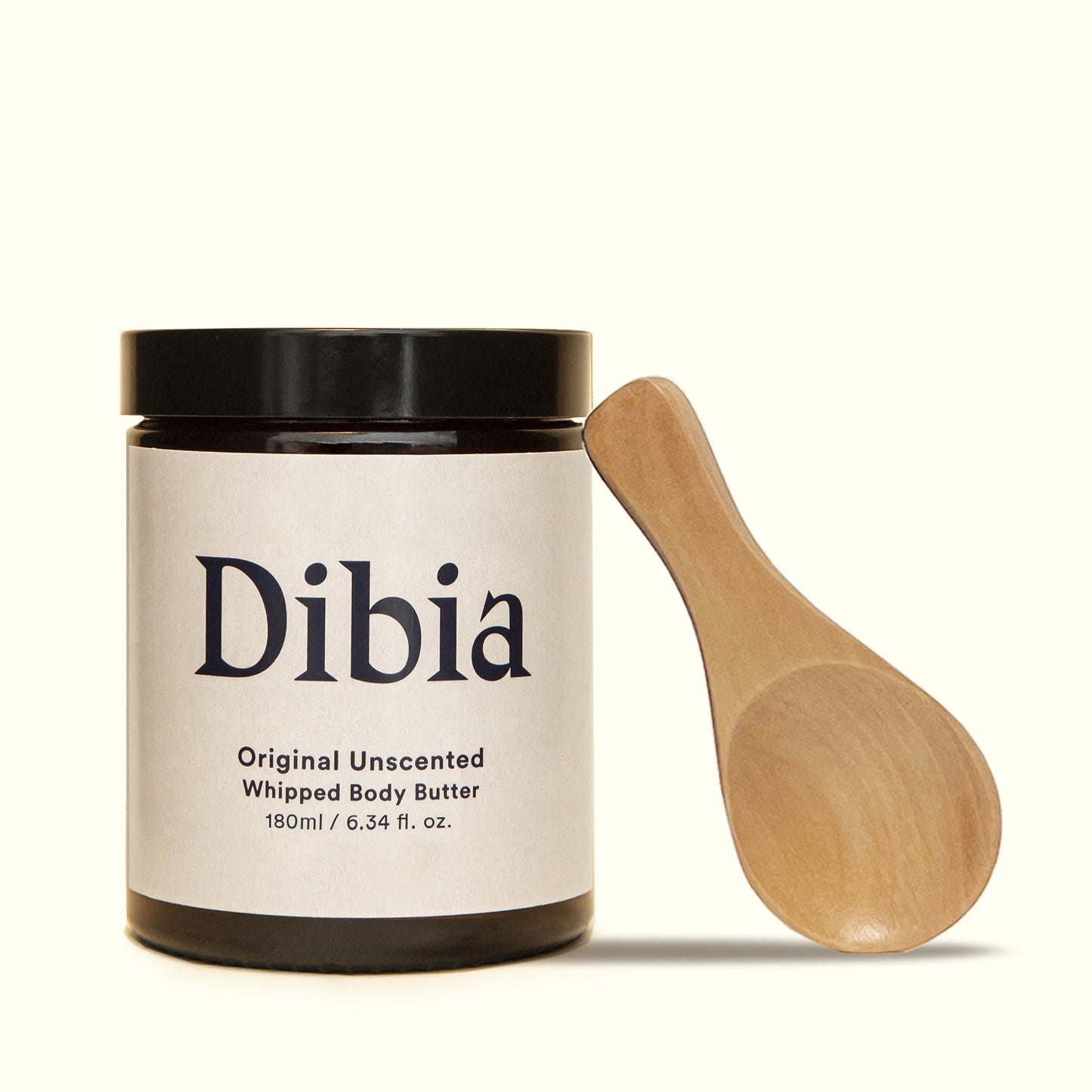 Jar of Dibia Original Unscented Whipped Body Butter 180ml with wooden scoop balanced on its side